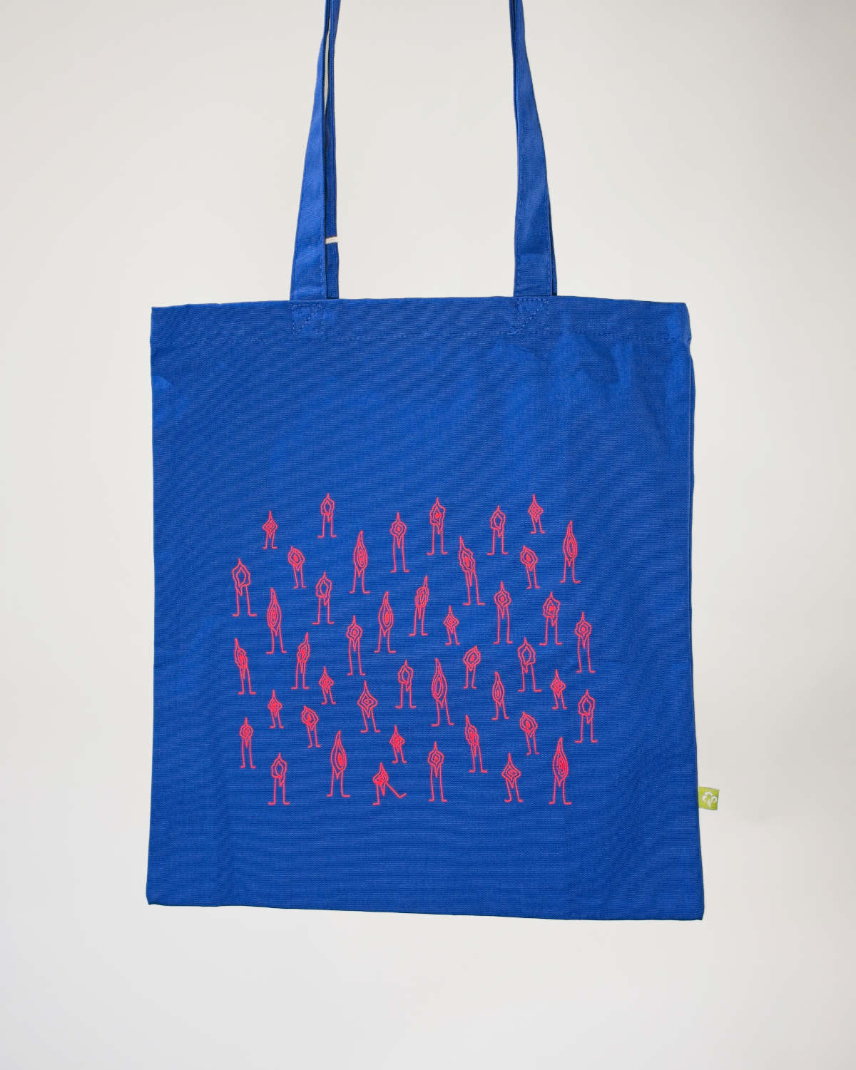 Eine blaue Tote Bag mit rosa vulven stark abstrahiert/line Art bedruckt.